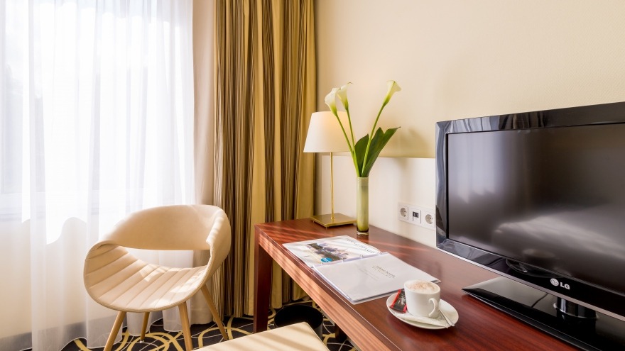 standard room with cappuccino on desk